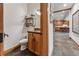 Powder room with wood cabinets, granite countertops, and a view into the open kitchen at 384 Camron Ln, Breckenridge, CO 80424