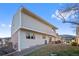 Rear exterior view of home showing backyard with patio, manicured lawn, and mountain views at 145 Willowleaf Dr, Littleton, CO 80127