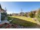 Expansive backyard with lush green grass and landscaped borders, perfect for outdoor activities at 10681 Sundial Rim Rd, Highlands Ranch, CO 80126