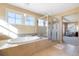 Bathroom with soaking tub, glass shower, and natural light at 10681 Sundial Rim Rd, Highlands Ranch, CO 80126