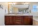 Bathroom with double sink vanity, large mirror, and modern fixtures at 10681 Sundial Rim Rd, Highlands Ranch, CO 80126