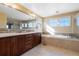Bathroom with double sink vanity, soaking tub, and modern fixtures at 10681 Sundial Rim Rd, Highlands Ranch, CO 80126