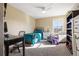Bedroom with an office space, chair, and bright window at 10681 Sundial Rim Rd, Highlands Ranch, CO 80126