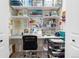 Bright craft room with well-organized storage, shelving, and a sewing machine, perfect for creative projects at 10681 Sundial Rim Rd, Highlands Ranch, CO 80126
