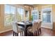 Bright dining room features hardwood floors, natural light from many windows, and a stylish chandelier at 10681 Sundial Rim Rd, Highlands Ranch, CO 80126