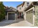 Inviting home exterior showcases a two-car garage, a single-car garage, and a charming red front door at 10681 Sundial Rim Rd, Highlands Ranch, CO 80126