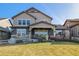 Charming two-story home with a well-manicured lawn and inviting covered front porch at 10681 Sundial Rim Rd, Highlands Ranch, CO 80126