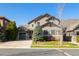 Charming two-story home featuring a well-manicured lawn, beautiful trees, and a three-car garage, all beneath a clear blue sky at 10681 Sundial Rim Rd, Highlands Ranch, CO 80126