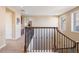 Upstairs hallway with a view of built-in cabinets and a staircase with iron and wood banisters at 10681 Sundial Rim Rd, Highlands Ranch, CO 80126