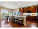 Modern kitchen features a large island with seating, stainless steel appliances, and stylish pendant lighting at 10681 Sundial Rim Rd, Highlands Ranch, CO 80126