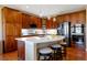 Modern kitchen boasts a large island with seating, stainless steel appliances, and dark wood cabinetry at 10681 Sundial Rim Rd, Highlands Ranch, CO 80126