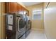 Convenient laundry room featuring a modern washer and dryer, and built-in cabinets at 10681 Sundial Rim Rd, Highlands Ranch, CO 80126