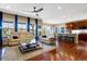 Spacious living room featuring hardwood floors, a ceiling fan, and an open layout that flows into the kitchen at 10681 Sundial Rim Rd, Highlands Ranch, CO 80126
