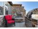Outdoor kitchen featuring a stone fireplace, built-in grill, and seating area, great for outdoor entertaining at 10681 Sundial Rim Rd, Highlands Ranch, CO 80126