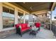 Covered patio with comfortable seating and an outdoor fireplace, perfect for relaxation and entertaining at 10681 Sundial Rim Rd, Highlands Ranch, CO 80126