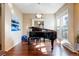 Elegant music room featuring a grand piano and bright windows at 10681 Sundial Rim Rd, Highlands Ranch, CO 80126