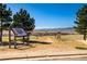 Picturesque view from the community trail overlooking the rolling hills and mountain range beyond at 10681 Sundial Rim Rd, Highlands Ranch, CO 80126