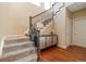 Carpeted staircase with an iron and wood banister, leading to the upper level of the home at 10681 Sundial Rim Rd, Highlands Ranch, CO 80126