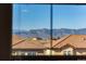 Scenic mountain view through window overlooking neighborhood rooftops at 10681 Sundial Rim Rd, Highlands Ranch, CO 80126