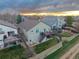 Aerial view of back of home with tiered patios, lush landscaping, and a fenced backyard at 17059 Motsenbocker Way, Parker, CO 80134