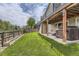 Manicured backyard with a concrete patio, lawn, privacy fence, and a covered hot tub at 17059 Motsenbocker Way, Parker, CO 80134