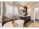 Elegant bathroom with a freestanding tub, double vanity, and stylish tile work at 17059 Motsenbocker Way, Parker, CO 80134