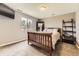 Bedroom featuring a queen sized bed, large mirror, and backyard views at 17059 Motsenbocker Way, Parker, CO 80134