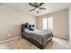 Cozy bedroom with a ceiling fan, carpeted floors, and natural light at 17059 Motsenbocker Way, Parker, CO 80134