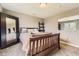 Bedroom featuring a queen sized bed, large mirror, and natural lighting at 17059 Motsenbocker Way, Parker, CO 80134