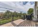 Wooden deck with a grill and a view of the backyard with privacy fence and mature trees at 17059 Motsenbocker Way, Parker, CO 80134