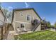 Back exterior view of home with tiered patios, well-maintained lawn, and beautiful landscaping at 17059 Motsenbocker Way, Parker, CO 80134