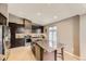 Open kitchen with a large island, stainless steel appliances, and a modern design at 17059 Motsenbocker Way, Parker, CO 80134