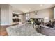 Inviting living room adjacent to the kitchen with hardwood floors and ample natural light at 17059 Motsenbocker Way, Parker, CO 80134