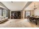 Open-concept living room with dining area, built-in shelving, and ample natural light at 17059 Motsenbocker Way, Parker, CO 80134