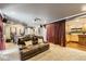 Spacious entertainment room featuring a large leather sofa, projector, and mini bar at 17059 Motsenbocker Way, Parker, CO 80134