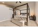 Spacious primary suite featuring a four-poster bed, neutral colors, and an ensuite bathroom at 17059 Motsenbocker Way, Parker, CO 80134