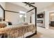 Serene primary bedroom with a stone fireplace, plush carpeting, and an ensuite bathroom at 17059 Motsenbocker Way, Parker, CO 80134