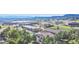 A sunny aerial view showcases the commercial area and landscaping of the community at 607 Branding Iron Ln, Castle Rock, CO 80104