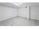 Unfinished basement with white walls and gray tile flooring presents a versatile space at 607 Branding Iron Ln, Castle Rock, CO 80104