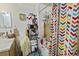Functional bathroom with a shower-tub combo and simple fixtures; needs decluttering at 607 Branding Iron Ln, Castle Rock, CO 80104