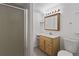 Bright bathroom with walk-in shower and vanity with warm wood cabinetry at 607 Branding Iron Ln, Castle Rock, CO 80104
