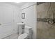 Bathroom featuring updated gray tile shower, white toilet and pedestal sink at 607 Branding Iron Ln, Castle Rock, CO 80104