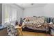 Bedroom with laminate wood floors, large window, and a queen bed at 607 Branding Iron Ln, Castle Rock, CO 80104