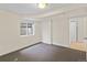 Bedroom featuring a window, neutral carpet and white trim, plus a convenient doorway to another room at 607 Branding Iron Ln, Castle Rock, CO 80104