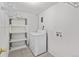 Bright laundry room features a white washer and dryer, and wire shelving for storage at 607 Branding Iron Ln, Castle Rock, CO 80104