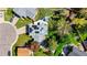 Aerial shot of a home featuring solar panels, patio with a hot tub, and lush landscaping at 6975 S Wadsworth Ct, Littleton, CO 80128