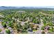 Scenic aerial shot of a residential neighborhood with lush greenery, views of mountains in the distance at 6975 S Wadsworth Ct, Littleton, CO 80128