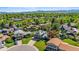 Suburban houses showcasing green lawns, mature trees, and mountain views, illustrating a peaceful neighborhood at 6975 S Wadsworth Ct, Littleton, CO 80128