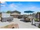 Outdoor patio area with a hot tub, dining table and grill at 6975 S Wadsworth Ct, Littleton, CO 80128