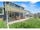 Covered back patio with furniture, ceiling fans, and a view of the grassy backyard at 6975 S Wadsworth Ct, Littleton, CO 80128